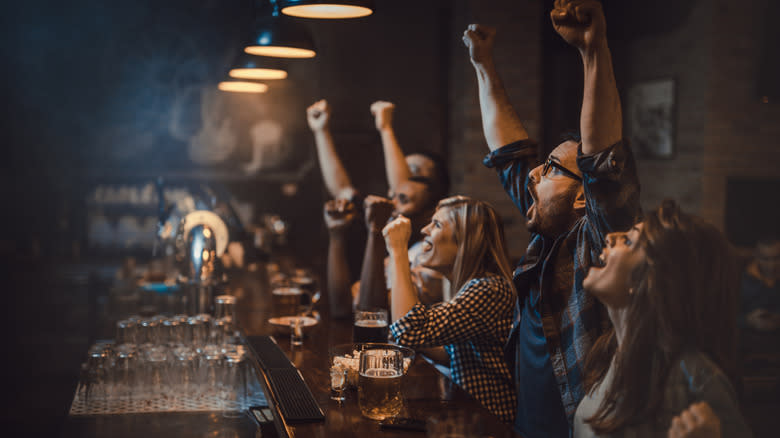 people cheering at bar