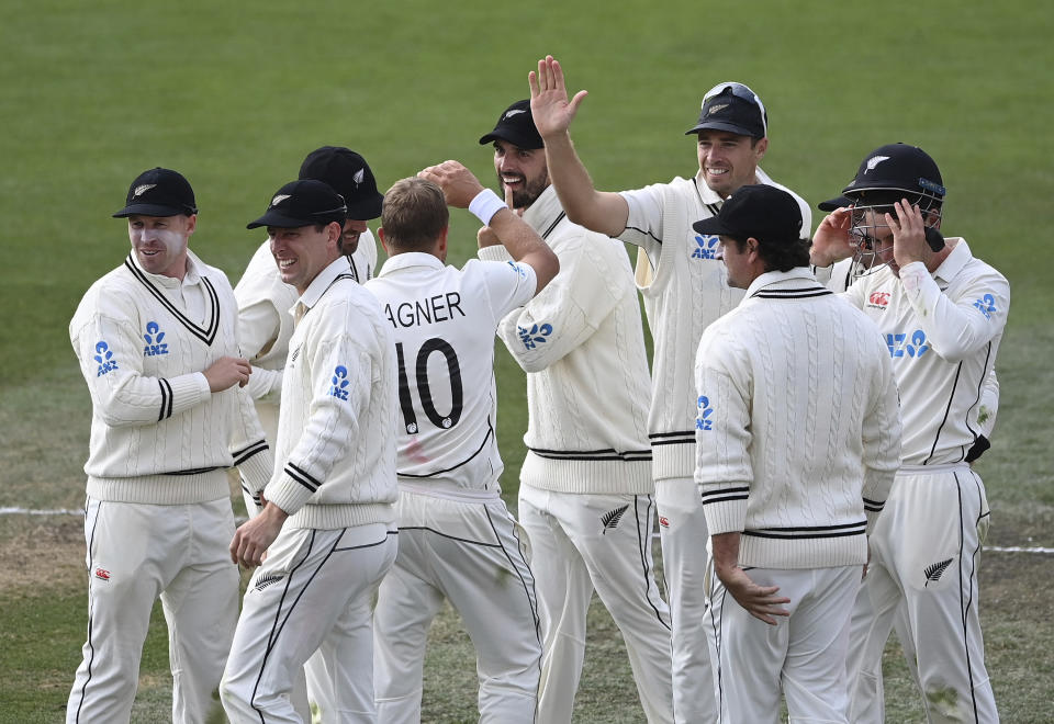 New Zealand bowler Neil Wagner (10) celebrates with teammates for the wicket of Rassie van der Dussen during play on day three of the second cricket test between South Africa and New Zealand at Hagley Oval in Christchurch, New Zealand, Sunday Feb. 27, 2022. (Andrew Cornaga/Photosport via AP)