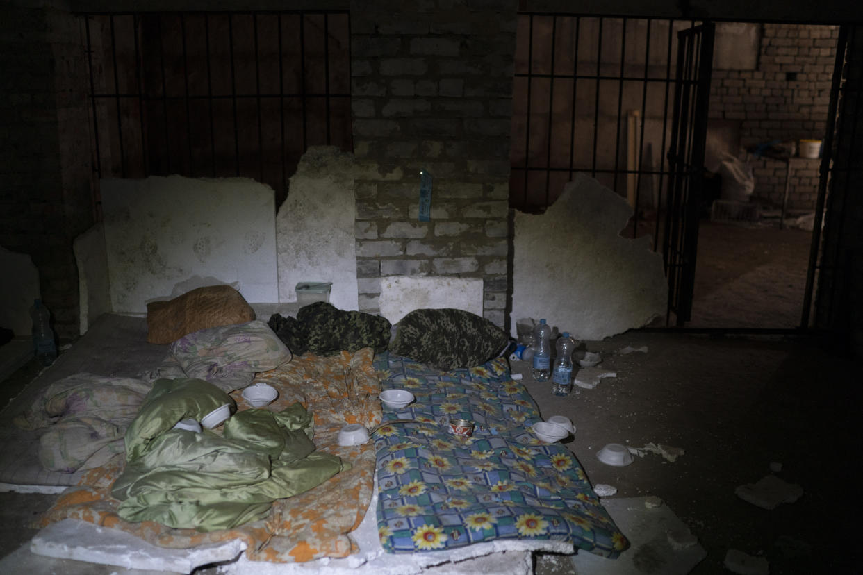Duvets and sleeping bag are seen in a basement which, according to Ukrainian authorities, was used as a torture cell during the Russian occupation, in the retaken village of Kozacha Lopan, Ukraine, Saturday, Sept. 17, 2022. (AP Photo/Leo Correa)