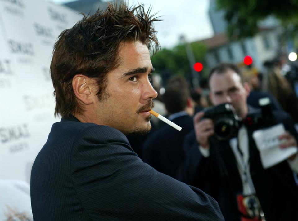 Colin Farrell on a red carpet with a cigarette in his mouth