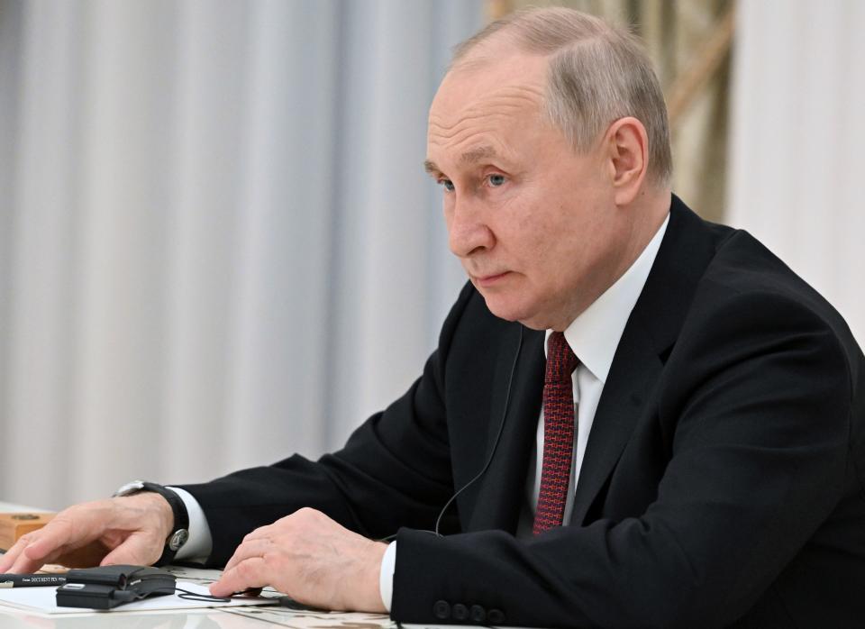 Russian President Vladimir Putin listens to China's Defense Minister Gen. Li Shangfu as Russian Defense Minister Sergei Shoigu attends the talks at the Kremlin in Moscow, Russia, Sunday, April 16, 2023. (Pavel Bednyakov, Sputnik, Kremlin Pool Photo via AP)