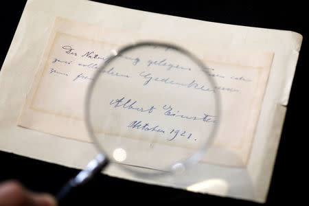 A note written by Albert Einstein to Italian chemistry student Elisabetta Piccini in Florence, Italy, in 1921 is seen before it is sold at an auction in Jerusalem, March 6, 2018. REUTERS/Ronen Zvulun