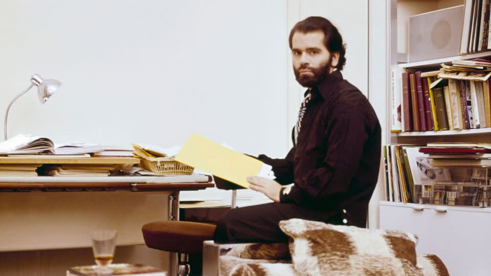 Here, the designer poses for a photo at the work desk in his office space. - Horst P Horst/Condé Nast/Shutterstock/Courtesy Thames & Hudson