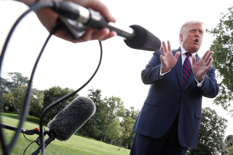 President Trump speaks to reporter at the South Lawn of the White House in Washington