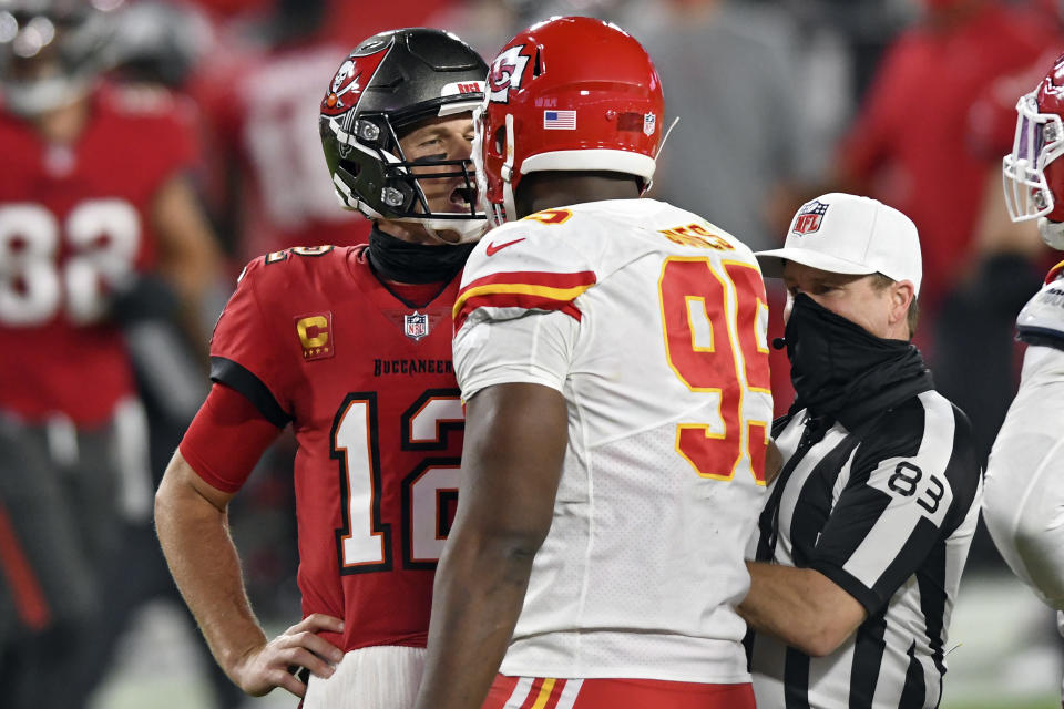 Tampa Bay Buccaneers quarterback Tom Brady (12) exchanges words with Kansas City Chiefs defensive tackle Chris Jones (95) as referee Shawn Hochuli (83) tries to separate the two during the second half of an NFL football game Sunday, Nov. 29, 2020, in Tampa, Fla. (AP Photo/Jason Behnken)