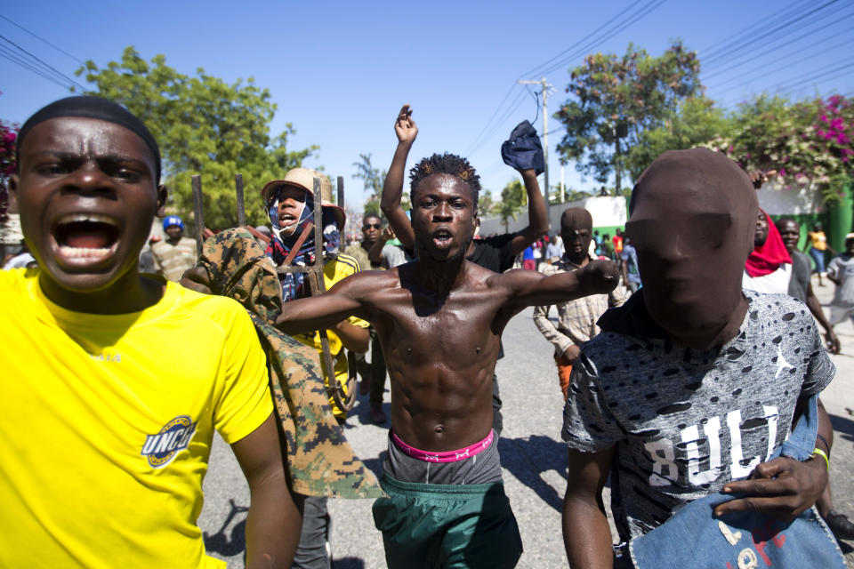 Protesters chant anti-government slogans demanding the resignation of President Jovenel Moise in Port-au-Prince, Haiti, Monday, Feb. 11, 2019. Protesters are angry about skyrocketing inflation and the government's failure to prosecute embezzlement from a multi-billion Venezuelan program that sent discounted oil to Haiti. (AP Photo/Dieu Nalio Chery)