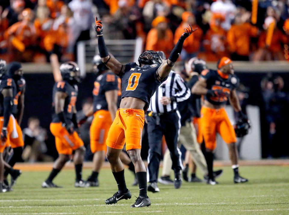 OSU's Christian Holmes (0) celebrates in the second half of a 37-33 win against OU on Saturday night at Boone Pickens Stadium in Stillwater.