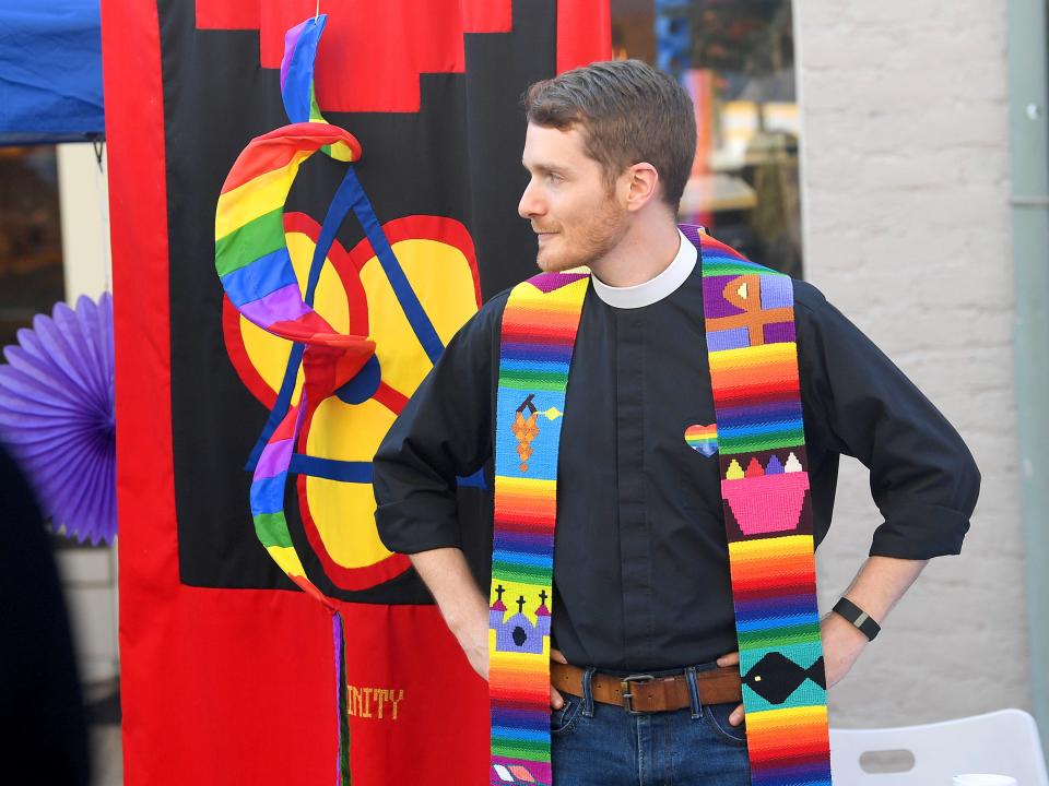 Chaplain Connor Gwin of Stuart Hall mans a booth at the Staunton Pride festival in downtown Staunton on Saturday, Oct. 6, 2018.
