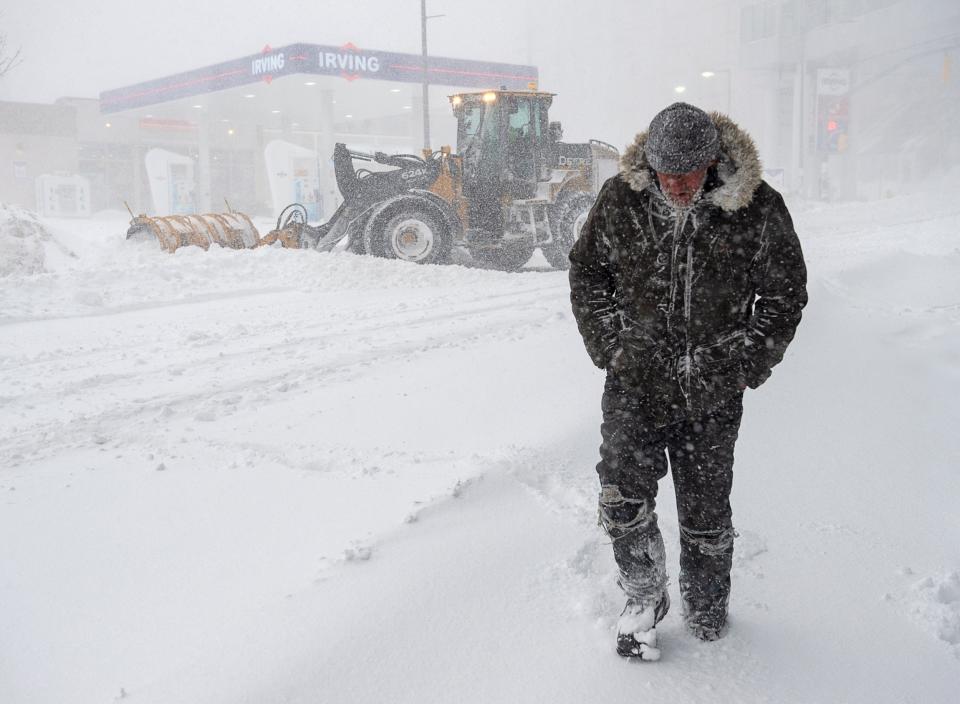 A resident trudges through the storm (AP)