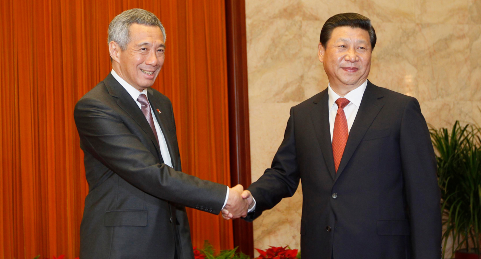 Singapore's Prime Minister Lee Hsien Loong, left, shakes hand with Chinese President Xi Jinping as they pose for photos prior to their meeting at the Great Hall of the People in Beijing, China, Monday, Aug. 26, 2013. (AP Photo/How Hwee Young, Pool)