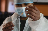 A health worker prepares a shot of the Johnson & Johnson COVID-19 vaccine during a vaccine campaign for anyone over age 18, at Universidad Mayor de San Andres public university in La Paz, Bolivia, Tuesday, Aug. 3, 2021. (AP Photo/Juan Karita)