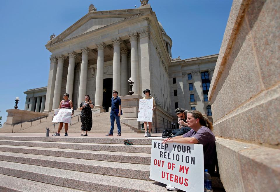 Demonstrators gather outside of the Oklahoma state Capitol to protest against the Supreme Court's decision to overturn legal abortions on Friday, June 24, 2022, in Oklahoma City, Okla. 