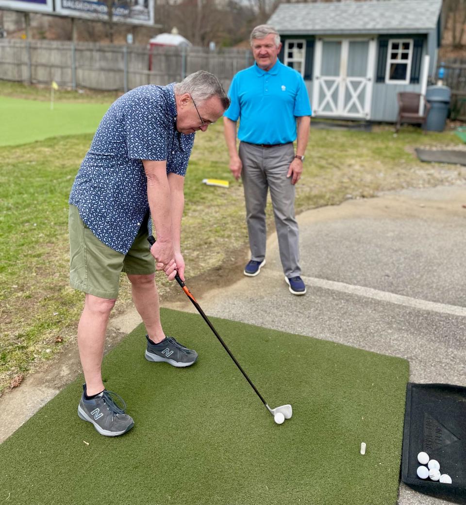 Rick Karbowski offers tips to Auburn's Jerry Hastings during a recent golf lesson at Auburn Driving Range.