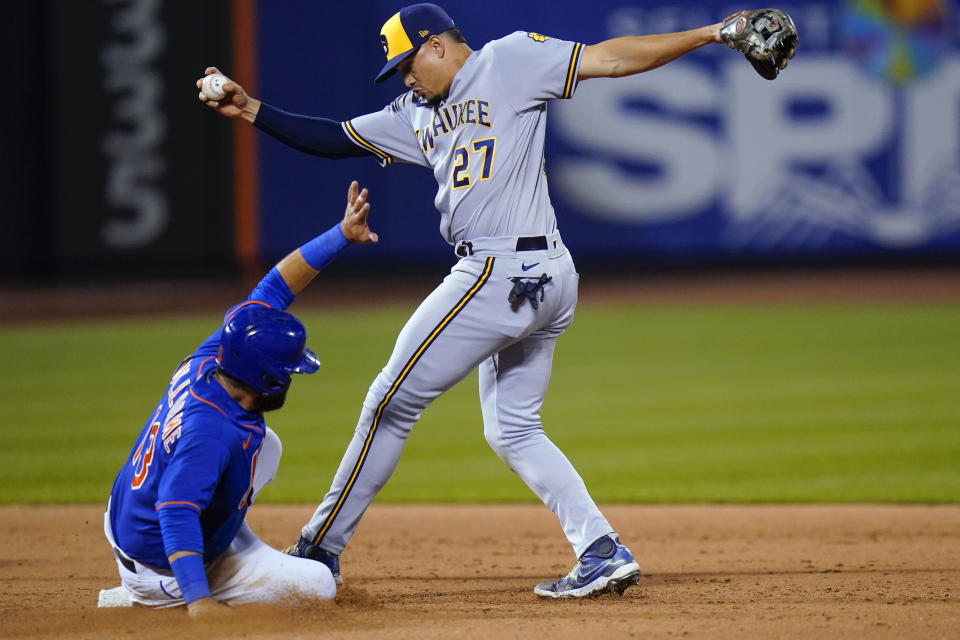 Milwaukee Brewers shortstop Willy Adames forces out New York Mets' Luis Guillorme (13) during the eighth inning of a baseball game Thursday, June 16, 2022, in New York. (AP Photo/Frank Franklin II)