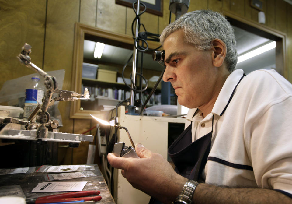 In this Thursday, June 14, 2012 photo, Mike Lamm works on a ring in his jewelry shop in Mediapolis, Iowa. These days, people aren’t buying much jewelry. What saves him is his ability to repair watches and make rings. There’s still enough call for that kind of work in the small town in rural southeastern Iowa. When the government reported that the Great Recession claimed nearly 40 percent of Americans' wealth, the figure alarmed economists. But for families across the country, the numbers merely confirm that they are not alone. (AP Photo/Charlie Neibergall)