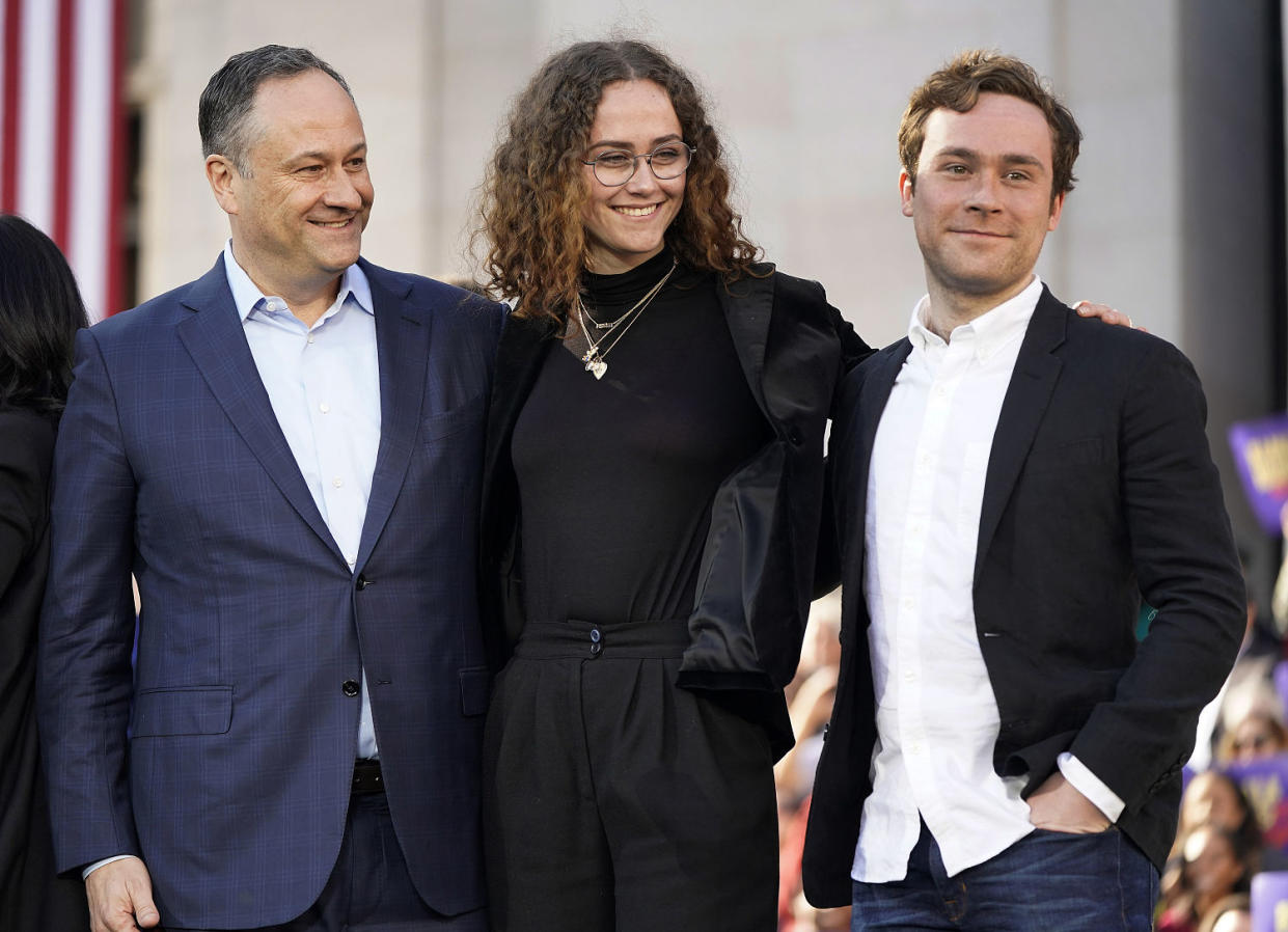 Doug Emhoff, Ella and Cole smile standing next to each other (Tony Avelar / AP file)