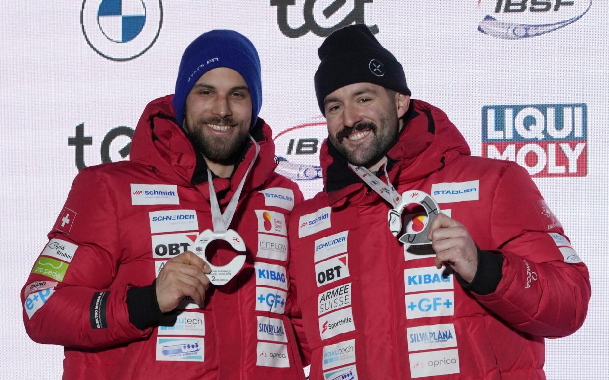 Swiss brakeman Sandro Michel (left) and pilot Michael Vogt/British Bobsleigh team quits World Cup race over horror injury to Swiss brakeman