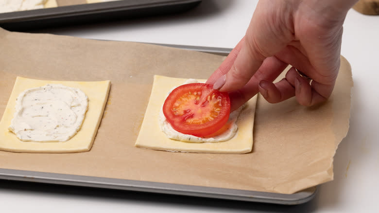 placing tomatoes on pastry