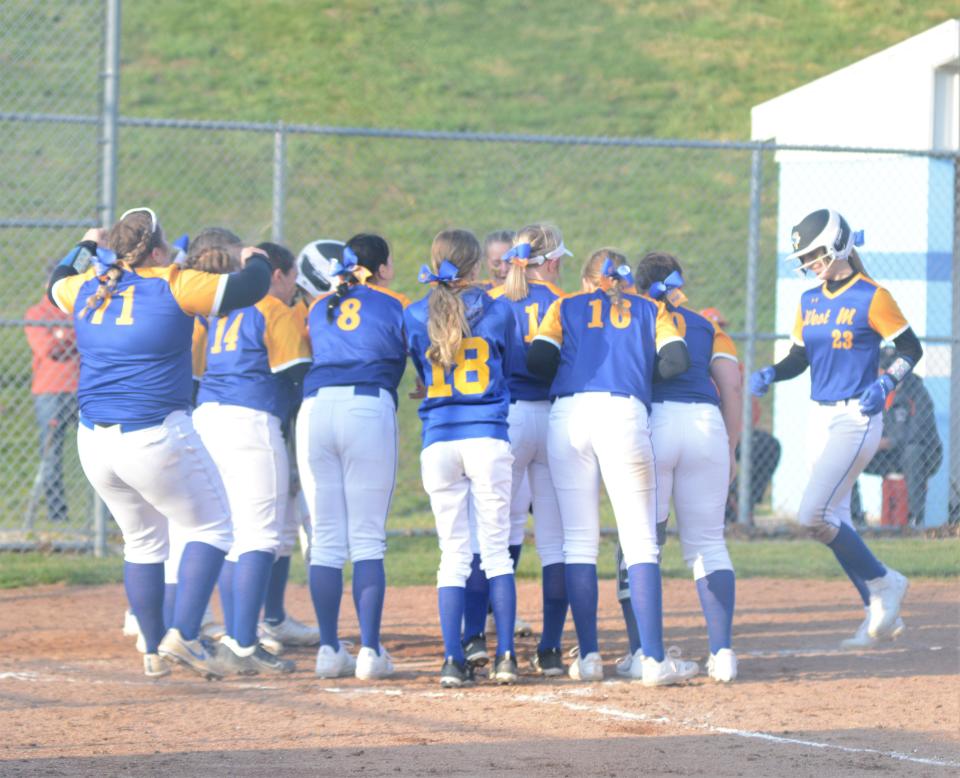 West Muskingum's Gabbi Hammer is welcomed home by teammates after hitting a home run in Monday's 6-5 win against Meadowbrook.