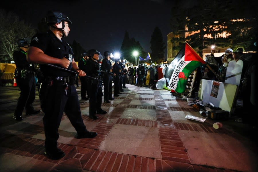 Pro-Palestinian students stand their ground after police breached their encampment the campus of the University of California, Los Angeles (UCLA) in Los Angeles, California, early on May 2, 2024. (Photo by ETIENNE LAURENT/AFP via Getty Images)