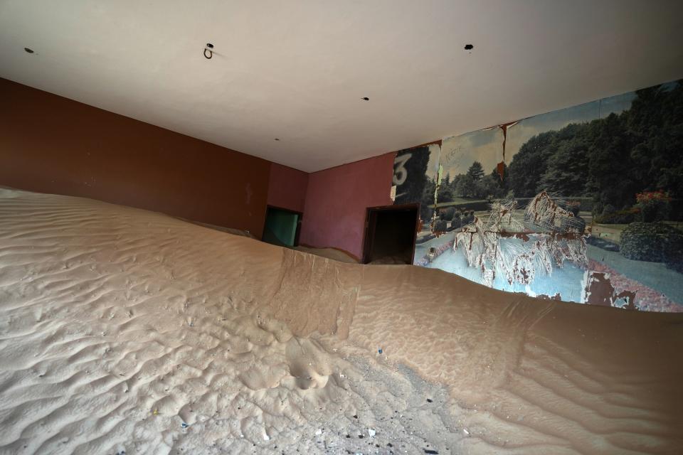 Sand is piled in a house at the Bedouin village of al-Ghuraifabout 100 km, 62 miles, southeast of Sharjah, United Arab Emirates, Sunday, July 9, 2023. Built-in the 1970s, the village was abandoned two decades later as oil wealth transformed the country into a global hub of commerce and tourism, home to the futuristic cities of Dubai and Abu Dhabi. (AP Photo/Kamran Jebreili)