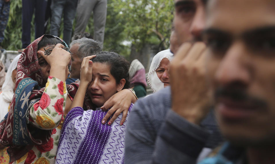 Family members and villagers grieve during the cremation ceremony of an Indian Army soldier Varun Katal in village Mawa in Samba district, 62 kilometers (51 miles) from Jammu, India, Sunday, Nov. 11, 2018. An Indian soldier was killed when Pakistani soldiers fired at Indian positions along the highly militarized frontier in disputed Kashmir on Saturday, Indian military said. (AP Photo/Channi Anand)