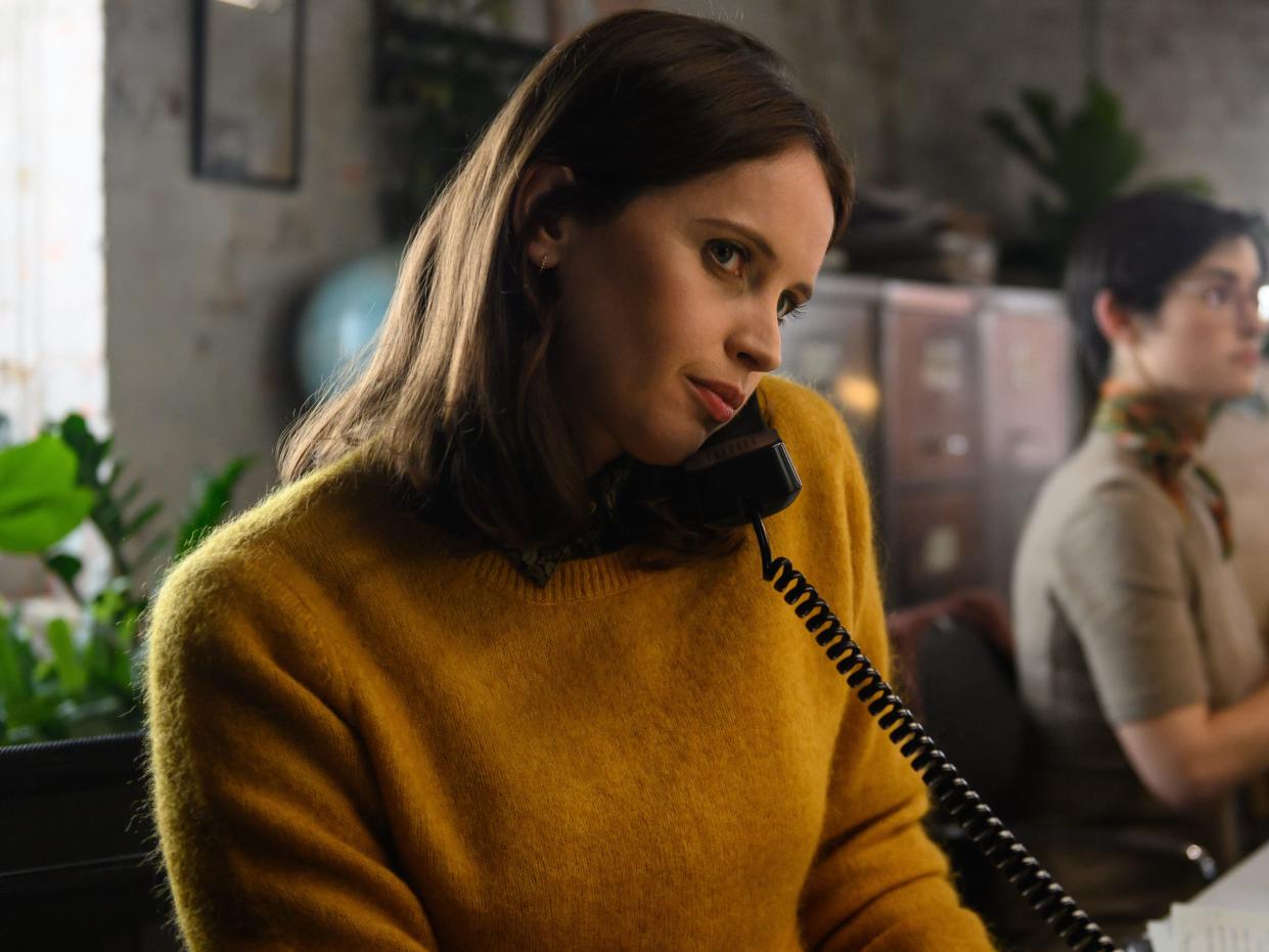 felicity jones as ellie haworth in the last letter from your lover, in a newsroom taking phone call