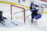 Winnipeg Jets' Mark Scheifele (55) hits Montreal Canadiens' Jake Evans (71) after Evans scored an empty-net goal during the third period of Game 1 of an NHL hockey Stanley Cup second-round playoff series Wednesday, June 2, 2021, in Winnipeg, Manitoba. (John Woods/The Canadian Press via AP)