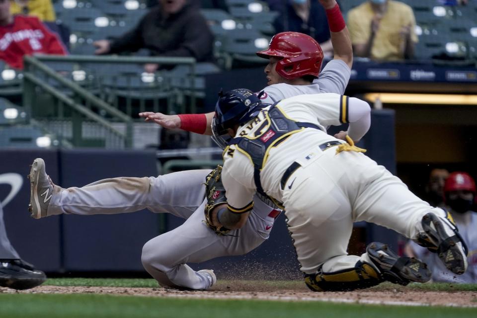 Milwaukee Brewers catcher Omar Narvaez tags out St. Louis Cardinals' Tommy Edman at home during the seventh inning of a baseball game Thursday, May 13, 2021, in Milwaukee. Edman tries to score from third on a fly ball hit by Paul Goldschmidt. (AP Photo/Morry Gash)