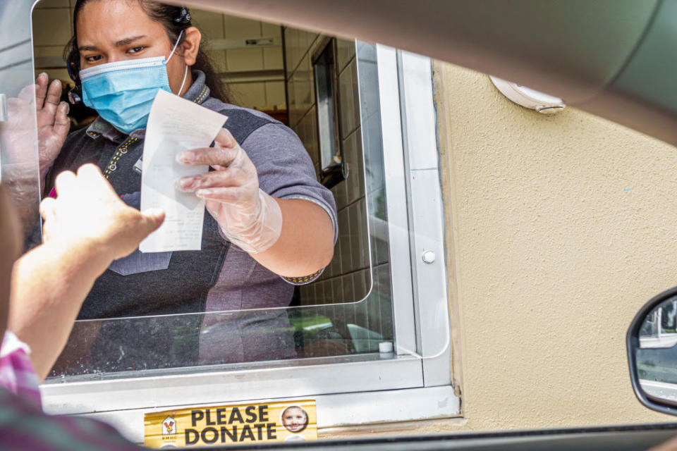 A teen works the drive-thru window