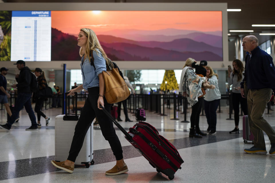 A Traveler makes their way through the Nashville International Airport, Tuesday, Nov. 21, 2023, in Nashville, Tenn. Despite inflation and memories of past holiday travel meltdowns, millions of people are expected to hit airports and highways in record numbers over the Thanksgiving Day break. (AP Photo/George Walker IV)