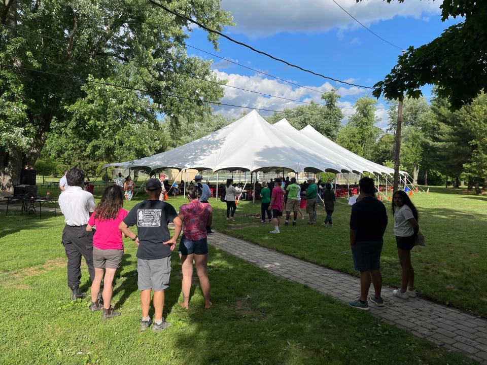 Community members gather outside to celebrate College Settlement Camp's 100 year anniversary and participate in its 90th annual June Supper on Thursday, June 9, 2022.