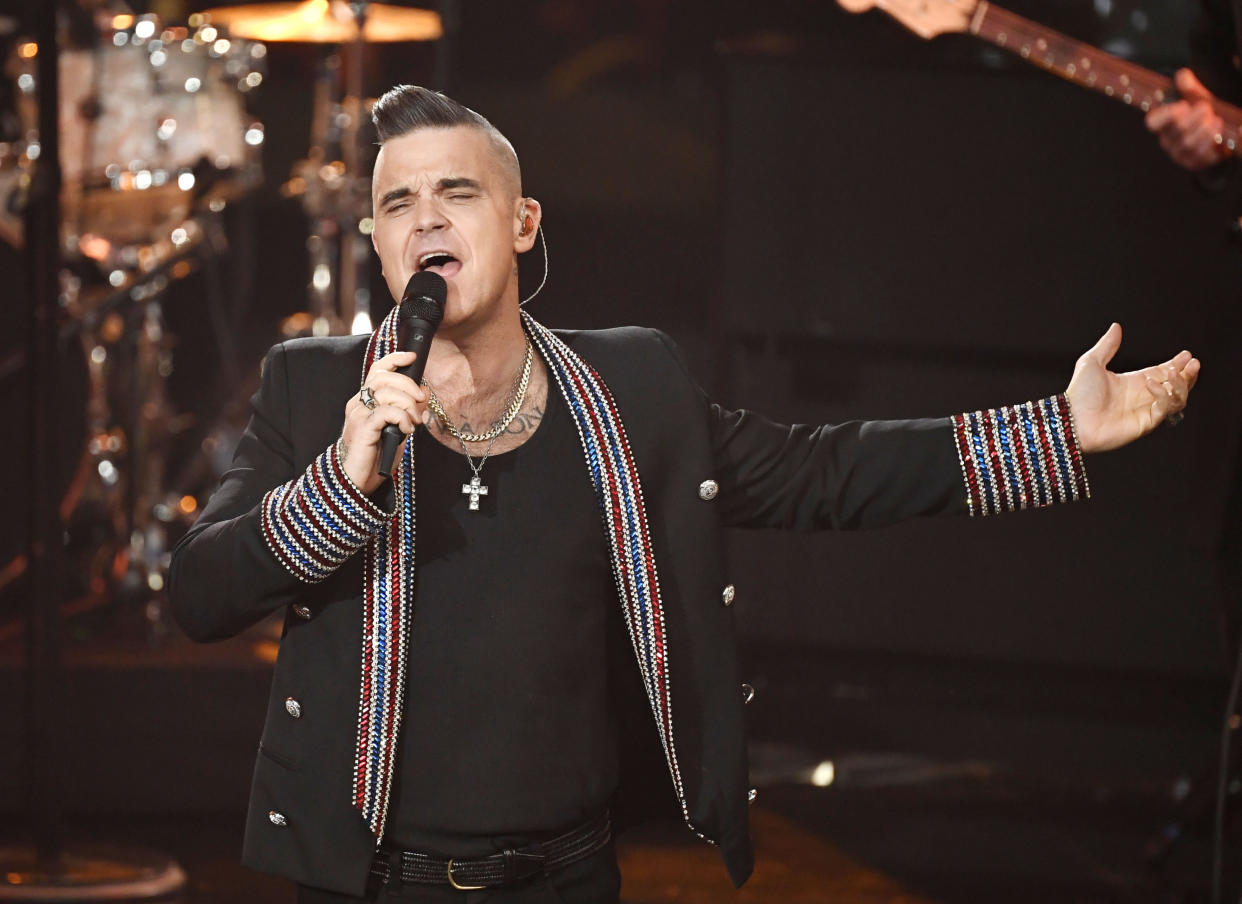 Singer Robbie Williams performs during the charity gala "Ein Herz fuer Kinder" (a heart for children) in Berlin, Germany, Saturday, Dec. 7, 2019. (AP Photo/Jens Meyer)