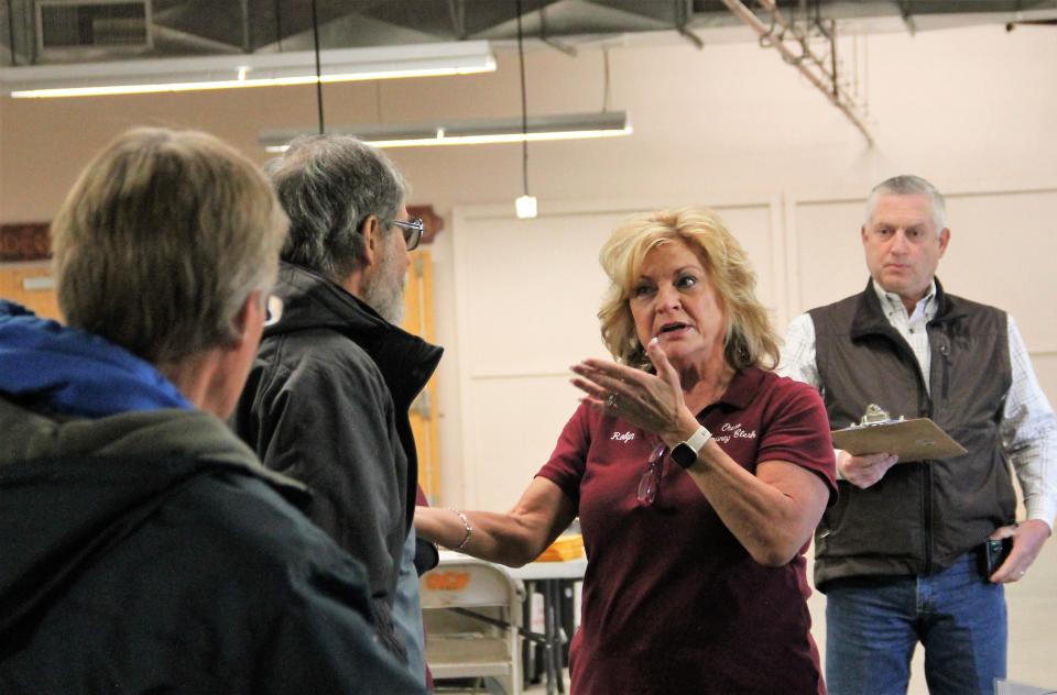 Otero County Clerk Robyn Holms, middle, speaks with a member of New Mexico Audit Force prior to the ballot rerun at the Otero County Fairgrounds on March 9, 2022 while Otero County Undersheriff Sean Jett looks on.

One of the facets of the Otero County 2020 Election Audit is an inspection and rerun of all the ballots that were  cast during the 2020 General Election.