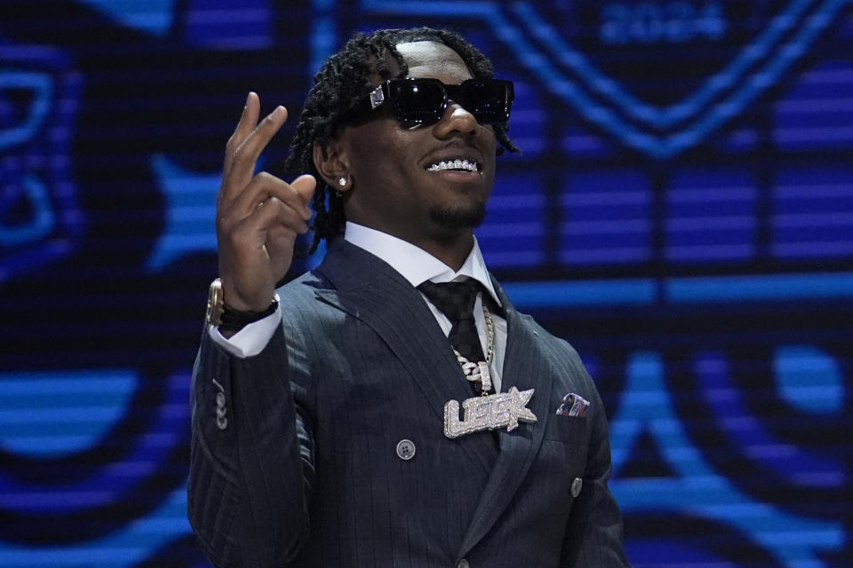 Toledo cornerback Quinyon Mitchell walks on stage during the first round of the NFL football draft, Thursday, April 25, 2024, in Detroit. (AP Photo/Jeff Roberson)