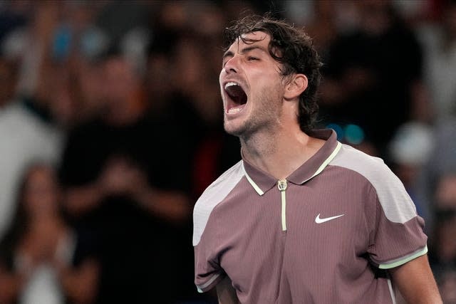 Taylor Fritz celebrates after defeating Stefanos Tsitsipas