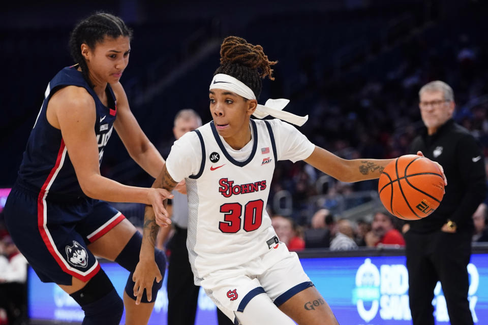 St. John's Kadaja Bailey (30) drives past Connecticut's Azzi Fudd (35) during the first half of an NCAA basetball game Wednesday, Jan. 11, 2023, in New York. (AP Photo/Frank Franklin II)