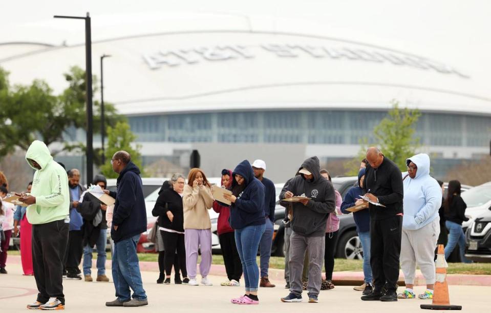 Family members wait in line to be reunited with students at the Arlington ISD Athletics Center on Monday, March 20, 2023. One student was killed and another injured in a shooting Monday morning at Lamar High, causing a lockdown. Arlington police arrested a suspect.