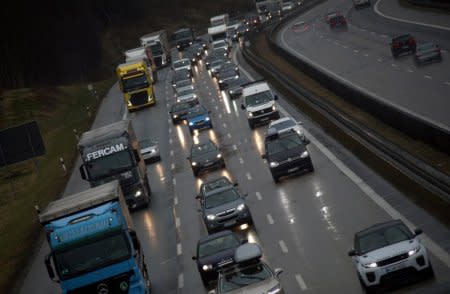 FILE PHOTO: Cars and trucks are stuck in a traffic jam near Irschenberg, Germany, March 29, 2018. REUTERS/Michael Dalder/File Photo