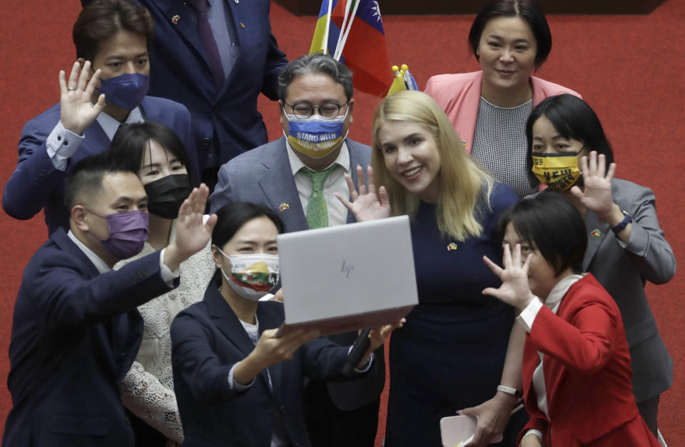 Ukrainian lawmaker Kira Rudik , center right, streams live to Ukraine people at the assembly hall of Taiwan Legislative Yuan in Taipei, Taiwan, Tuesday, Oct. 25, 2022. (AP Photo/Chiang Ying-ying)