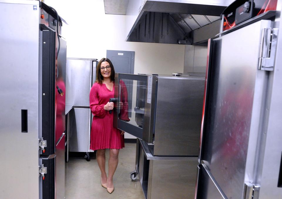 Executive Director Brandy Scheetz stands in the fully equipped kitchen where hot breakfasts and lunches for the children will be made.