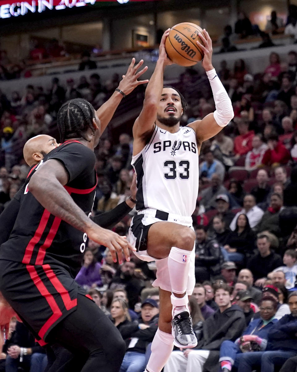 San Antonio Spurs' Tre Jones (33) drives and shoots during the first half of an NBA basketball game against the Chicago Bulls, Thursday, Dec. 21, 2023, in Chicago. (AP Photo/Charles Rex Arbogast)