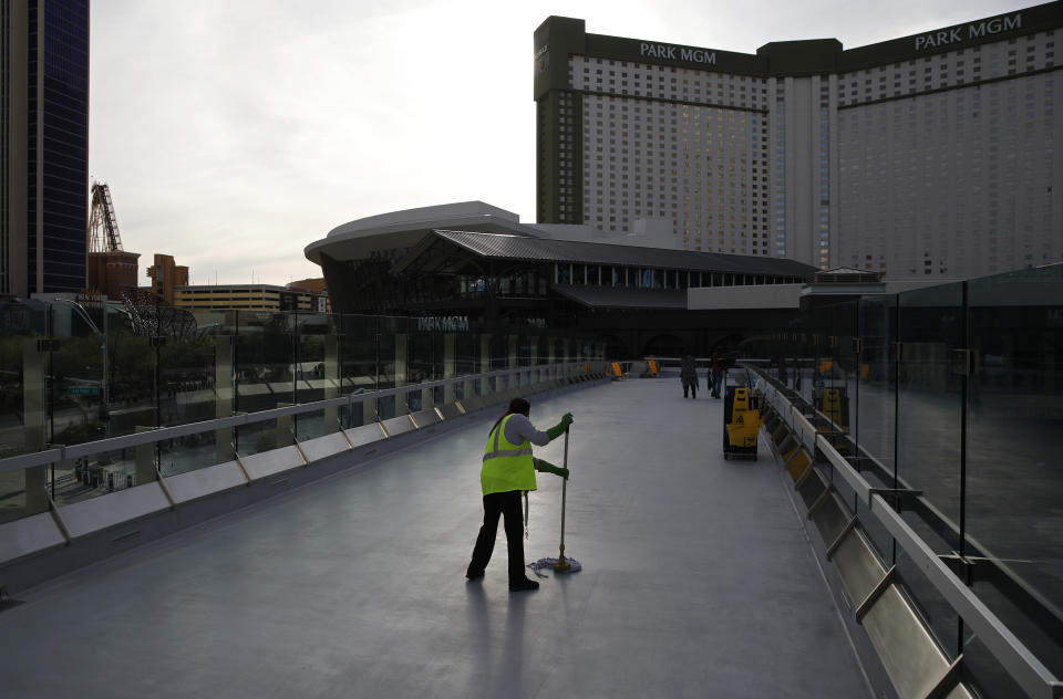 FILE - In this March 31, 2020, file photo, a worker cleans along the Las Vegas Strip devoid of the usual crowds as casinos and other business are shuttered due to the coronavirus outbreak in Las Vegas. Nevada's troubled unemployment benefits program has been overhauled, and a "tsunami" of claims spurred by pandemic layoffs have largely been sorted. That's what the new department chief and the outgoing head of a governor-appointed strike force said Thursday, Jan. 28, 2021. (AP Photo/John Locher, File)