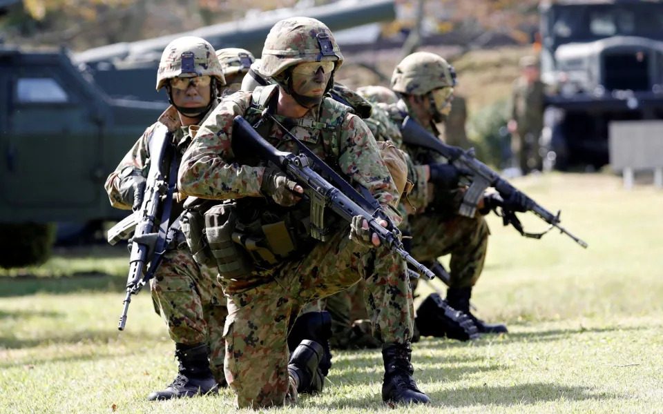 British and Japanese forces conduct a joint exercise at a military base in central Japan in November - TORU HANAI/REUTERS