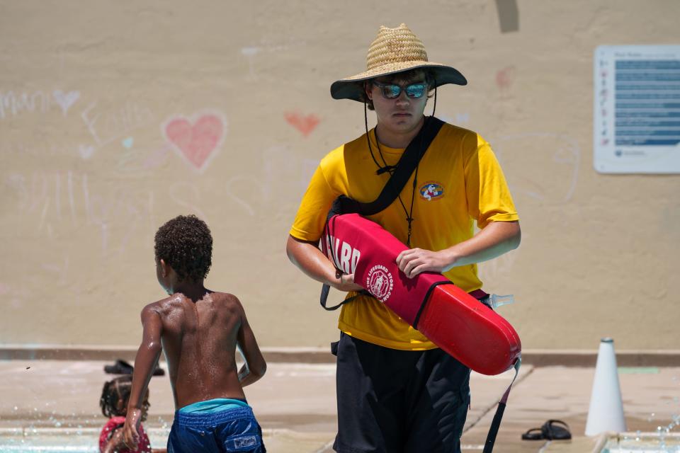 Lifeguard Bishop Bell looks down at the water while working at Harmon Pool on June 15, 2023, in Phoenix.