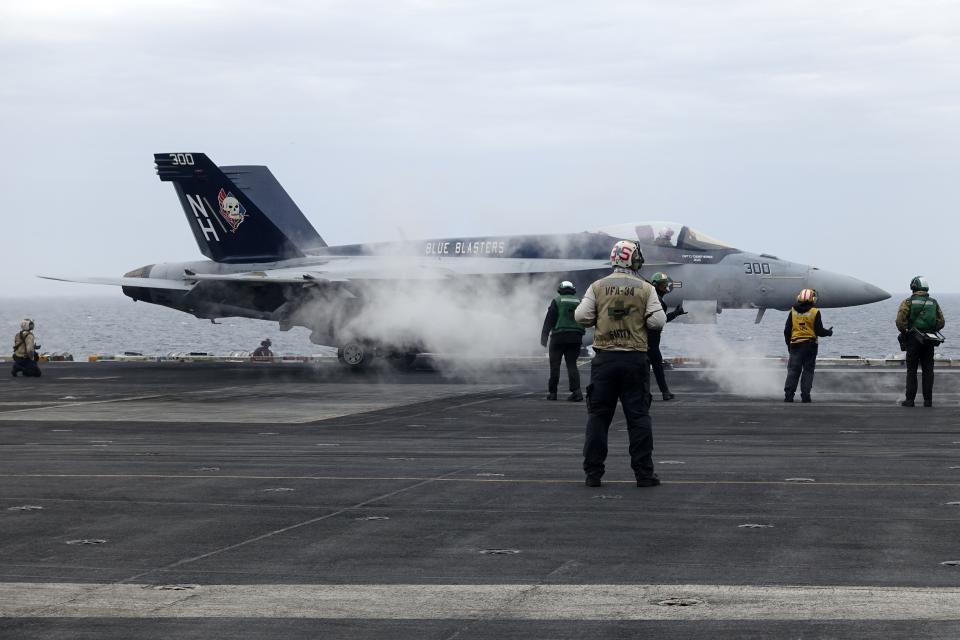 A F-18E fighter jet prepares to take off from USS Theodore Roosevelt aircraft carrier on Thursday April 11, 2024, during a three-day joint naval exercise by the U.S., Japanese and South Korea at the East China Sea amid tension from China and North Korea. (AP Photo/Mari Yamaguchi)