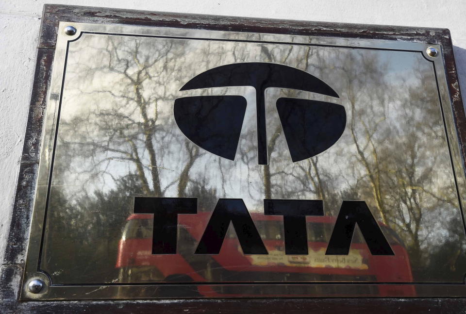 A bus is reflected in a Tata sign outside their offices in London, Britain March 30, 2016. REUTERS/Toby Melville      TPX IMAGES OF THE DAY     