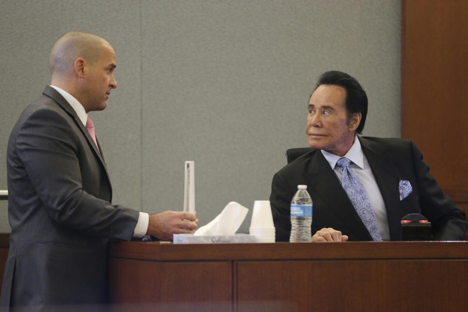 District Attorney John Giordani, left, speaks to Wayne Newton sitting in the witness stand, in the State of Nevada case against Weslie Martin, accused of burglarizing Newton's home, at the Regional Justice Center in Las Vegas, Tuesday, June 18, 2019. (Erik Verduzco/Las Vegas Review-Journal via AP)