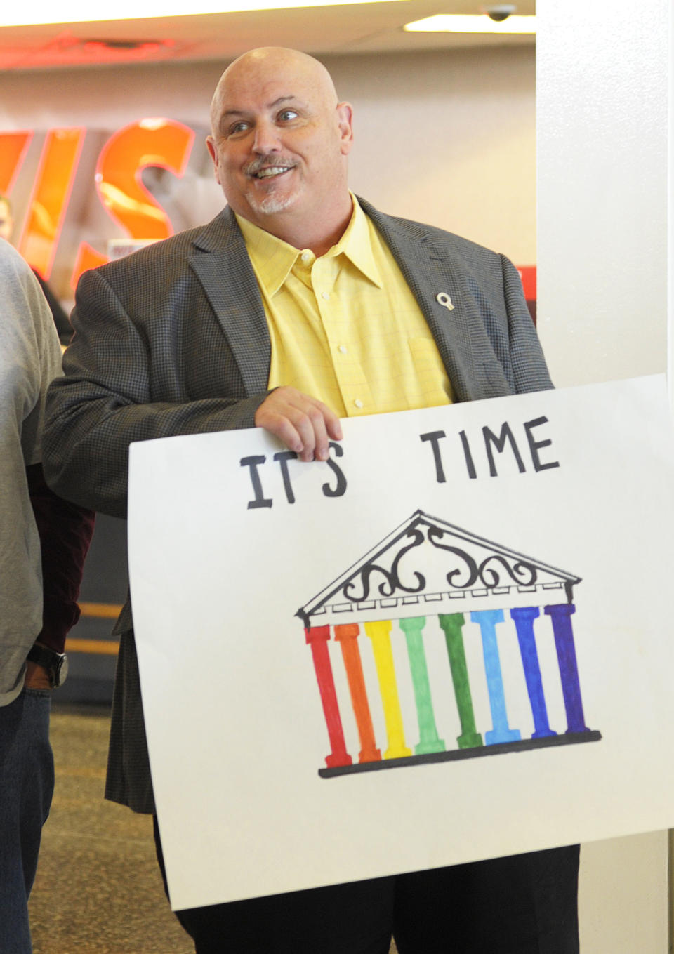 Toby Jenkins holds an "It's Time" sign as Oklahomans for Equality gathered at Tulsa International Airport with their signs for a send off celebration in support for the plaintiffs in the Oklahoma Marriage Equality lawsuit as they head to the 10th Circuit Court of Appeals in Denver Wednesday April 16, 2014. (AP Photo/Brandi Simons)