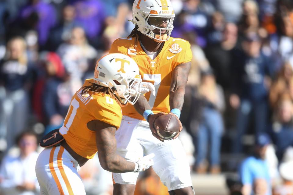 Tennessee quarterback Joe Milton III (7) hands off to running back Jaylen Wright (0) during an NCAA college football game between Connecticut and Tennessee on Saturday, November 4, 2023 in Knoxville, Tenn.